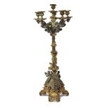 A French gilt and patinated bronze six light candelabrum, 19th century, with foliate sconces on