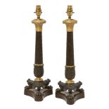 A pair of Charles X gilt and patinated bronze table lamps, c.1825, each with stiff-leaf capital