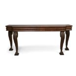 A William IV mahogany serving table, of breakfront outline with moulded frieze, on leaf carved