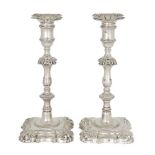 A pair of George II silver candlesticks, London, 1755, John Cafe, the shaped square bases with shell