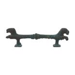 A Luristan bronze zoomorphic handle, circa 700BC, adorned with two lions heads terminals, with their