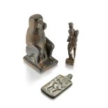 A group of three figures after the Antique, including a silver Harpocrates, 7.6 cm high; a stone
