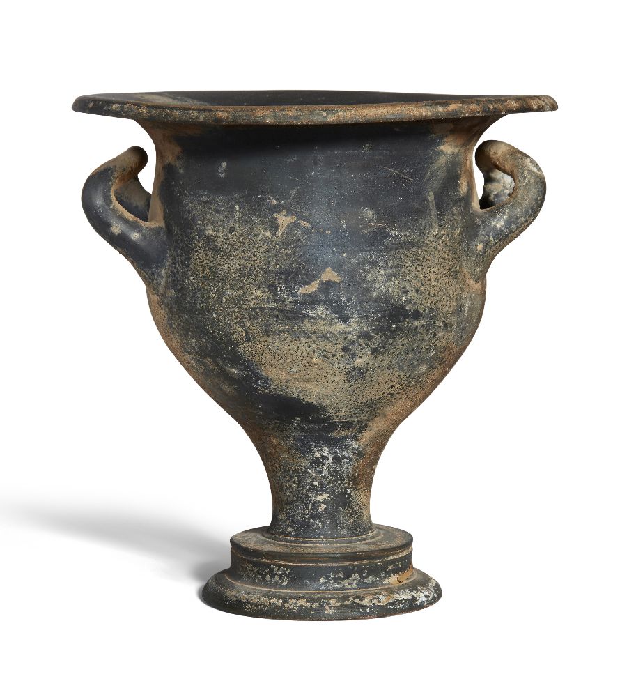 An Apulian black glazed bell krater with up-turned handles on a pedestal base, Magna Graecia,