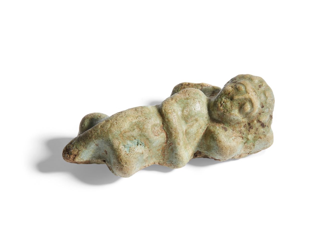 A Romano-Egyptian sleeping cupid in faience from the rim of a bowl, 1st-3rd century A.D. Provenance: