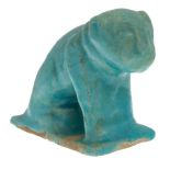 A Kashan moulded turquoise glazed pottery figure of a lion, Iran, 12th century, on a rectangular