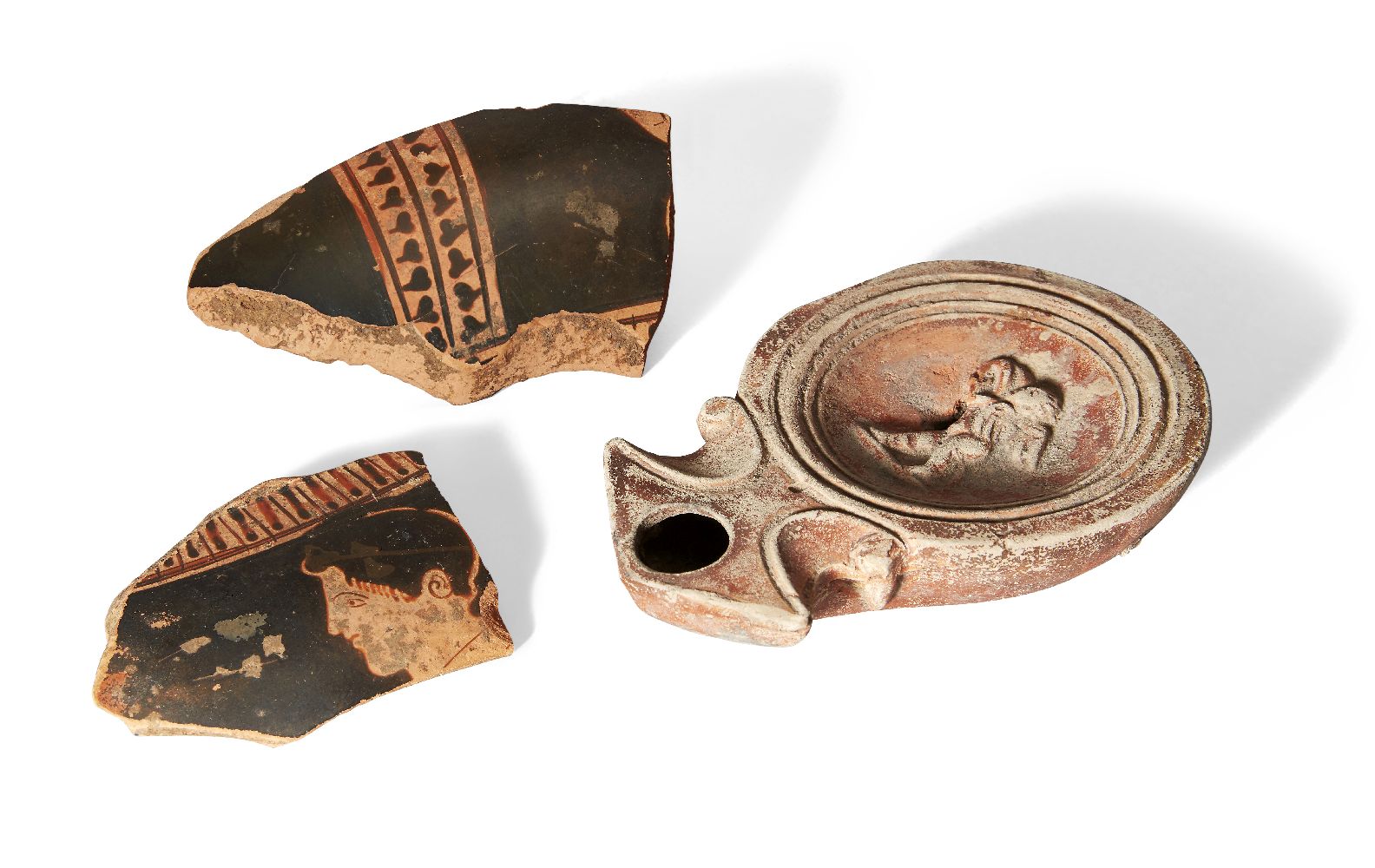 Two Greek red figure pottery vessel fragments, one with the profile head of a male, 6.9cm x 5.2cm