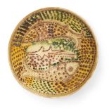 A sgraffito pottery bowl with fish, Iran, 12th century AD, a bowl with manganese, cream, green and