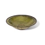 A large incised pottery green glazed bowl, Syria or Iran, 12th century, on a short foot, with an