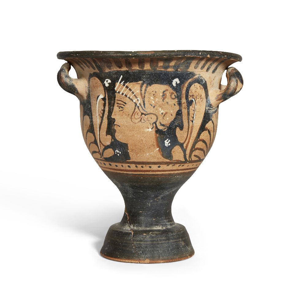 An Apulian red-figure bell krater, each side decorated with the head of a lady of fashion framed