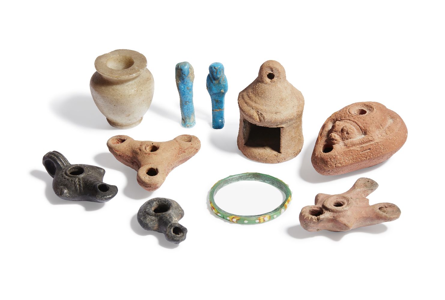A miscellaneous group of antiquities, including an Egyptian Middle Kingdom alabaster kohl jar, circa