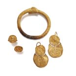 A group of gold items after the Antique, comprising a bracelet with ram head terminals, two rings,