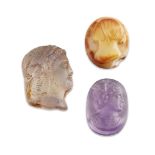 A group of three glass cameos, two carved with the bust portrait of a woman, the other of a youth,