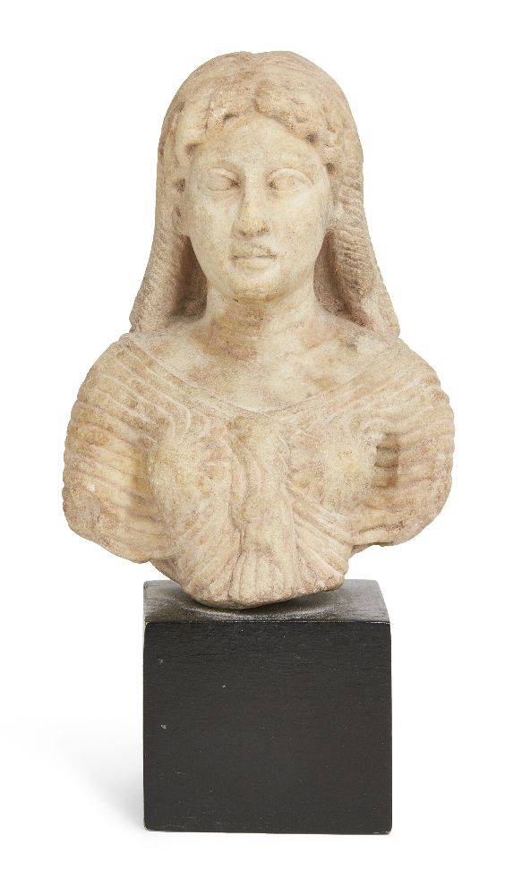 A Roman marble bust of Isis, circa 1st Century A.D., the wavy hair with central parting, falling