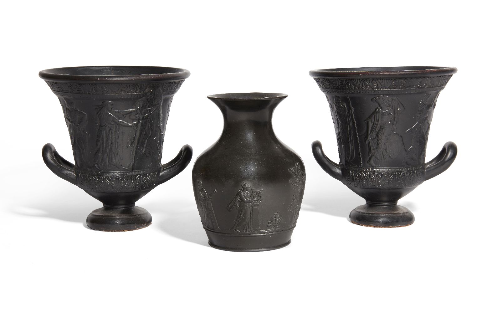 Three decorative black glazed vessels, including two kraters, with moulded decoration, 16.9cm.
