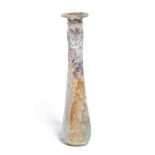 An iridescent Roman glass unguentarium, circa 1st Century A.D. , 11.8cm. high Provenance: Private