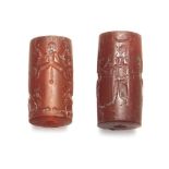 Two carnelian cylinder seals, Not Ancient, 2.6 cm and 3.2 cm long (2) Good overall