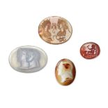 A group of four intaglios after the Antique, including a cameo of a youth, 3 cm. diam., 3.7 cm