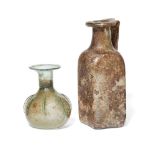 Two Roman green glass vessels, one a sprinkler flask with eight vertical pinched ribs, 9.4cm and a