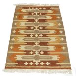 A Swedish flatweave wool kilim, c.1960/70, signed in the weave - 'MF', In light brown, yellow and