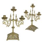 A pair of brass Gothic revival three branch candelabra, c.1870, each stamped with an illegible