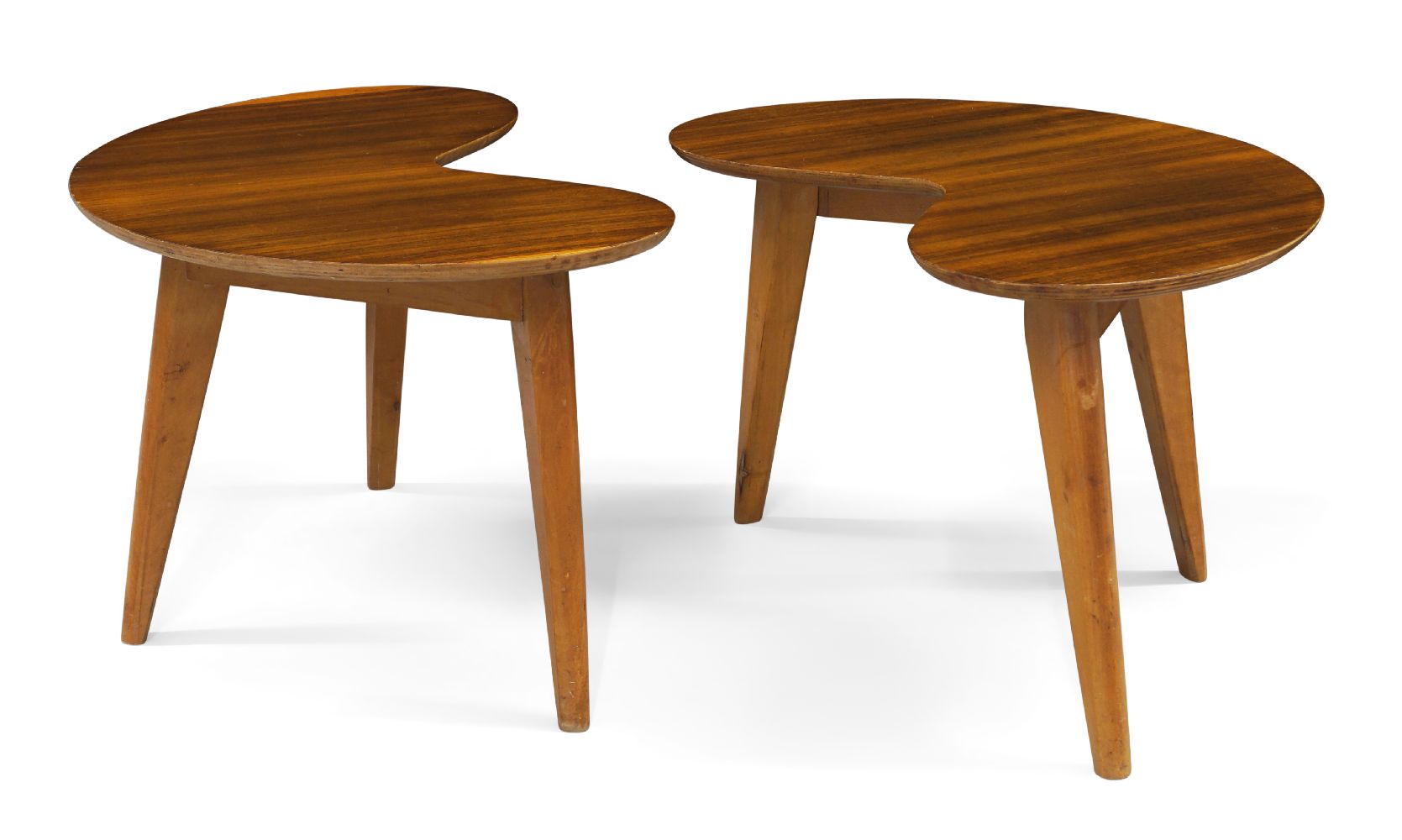 A pair of teak kidney shaped side tables, c.1950, The shaped tops on splayed and tapered birch