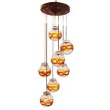 A Murano glass pendant light, late 20th Century, With seven lights set within clear and orange '