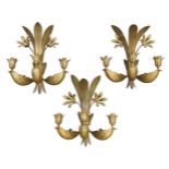 A set of three French water gilded wall lights, c.1960, Each with three light fixtures and with
