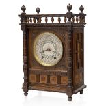 Elkington & Co, an oak cased mantle clock the design after or possibly by Lewis F Day, c.1880,