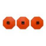 A set of three orange plastic and wall mounted coat hooks, c.1960, Of stepped octagonal form, with