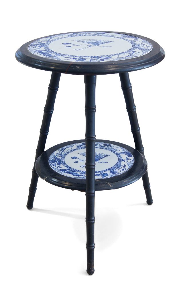 An Aesthetic Movement ebonised two tier occasional table, c.1870, With two graduated circular tiers,