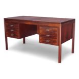 H.P Hansen (Danish), a rosewood kneehole desk, c.1960, The rectangular top above two banks of