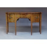 A George III mahogany and ebony strung sideboard, the shaped top above central frieze drawer flanked