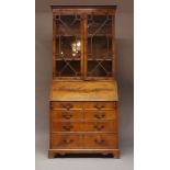 A George III style mahogany bureau bookcase, c.1910, the astragal glazed cabinet doors over