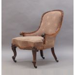 A Victorian rosewood framed nursing chair, with scroll arms, raised on cabriole legs and