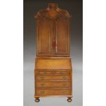 A Queen Anne style mahogany and leather covered bureau bookcase, mid-20th century, the moulded