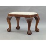 A George II style mahogany stool, early 20th Century, the cream upholstered drop in seat, on