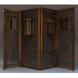 A mashrabiya four-fold wood screen, late 19th century, pierced panels with doors and niches, each