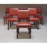 A set of six red leather upholstered dining chairs, late 19th, early 20th Century, with square backs