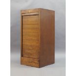 An Early 20th century oak tambour front cabinet, 97cm high, 44cm wide, 45cm deep (door is locked