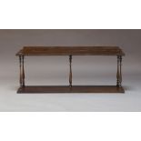 A mahogany wall shelf, 19th Century, with turned baluster supports, 47cm high, 109cm wide, 25cm deep