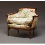 A Louis XV style carved beech canape, early 20th Century, the curved backrest with scrolling arms,