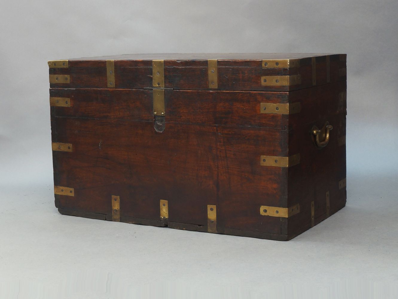 A brass bound oak twin handled campaign trunk, 19th century, 46cm high, 74cm wide, 46cm deepPlease