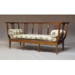 A French mahogany sofa, mid 20th Century, the backrest with slatted and column form supports, with