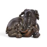 A Chinese bronze 'elephant' paperweight, late 19th/early 20th century, cast in a recumbent pose with