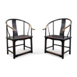 A pair of Chinese elm and black lacquered horseshoe back chairs, late Qing dynasty, with central