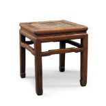 A Chinese elm square stool, late 19th century, the rattan inset top above open frieze on square