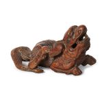 A Chinese carved wood figure of a lion, 18th/19th century, in a recumbent pose with long flowing