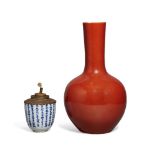 A Chinese porcelain coral-glazed bottle vase and a blue and white cup, the vase 19th century, the