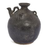 A Chinese pottery black-glazed ewer, Song dynasty, of globular form, the shoulder applied with three