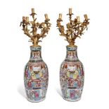 A pair of Chinese Canton porcelain famille rose vases with gilt metal candelabra mounts, 19th